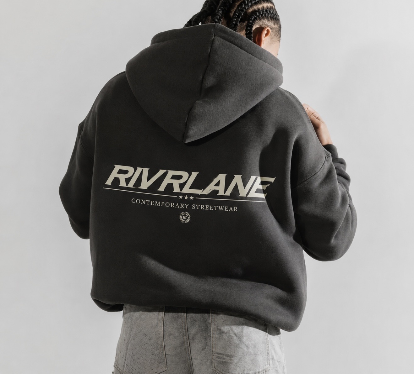 RIVRLANE model wearing the black branded hoodie